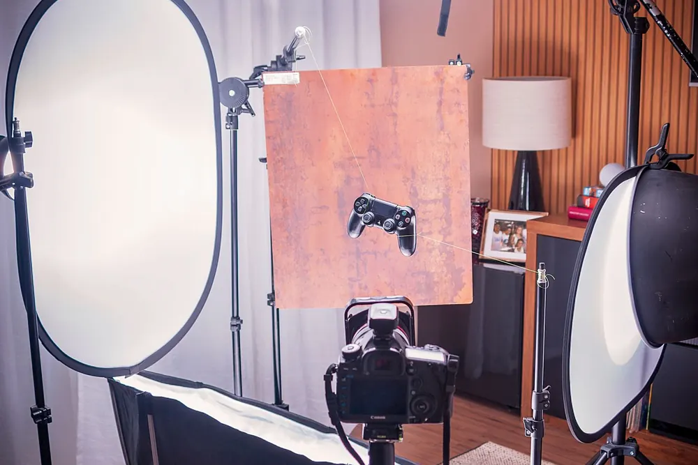 Product photography studio with camera, lights and reflector
