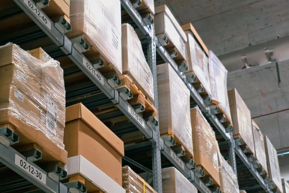 Warehouse shelves stacked with cardboard boxes